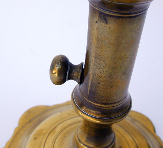 A Mid 18th Century English Push Up Brass Candlestick